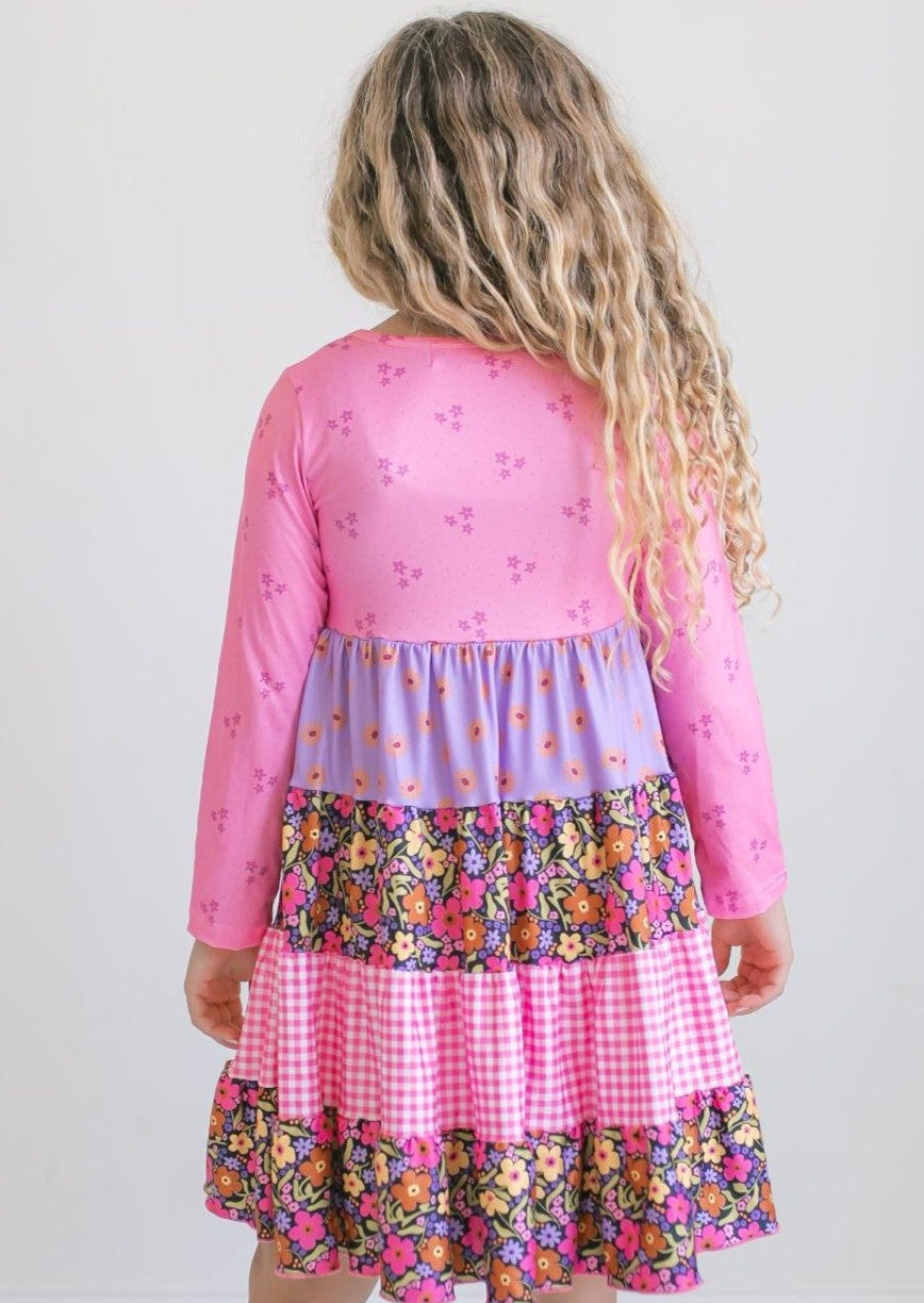Girls' bright pink floral dress showing long sleeves and full skirt.