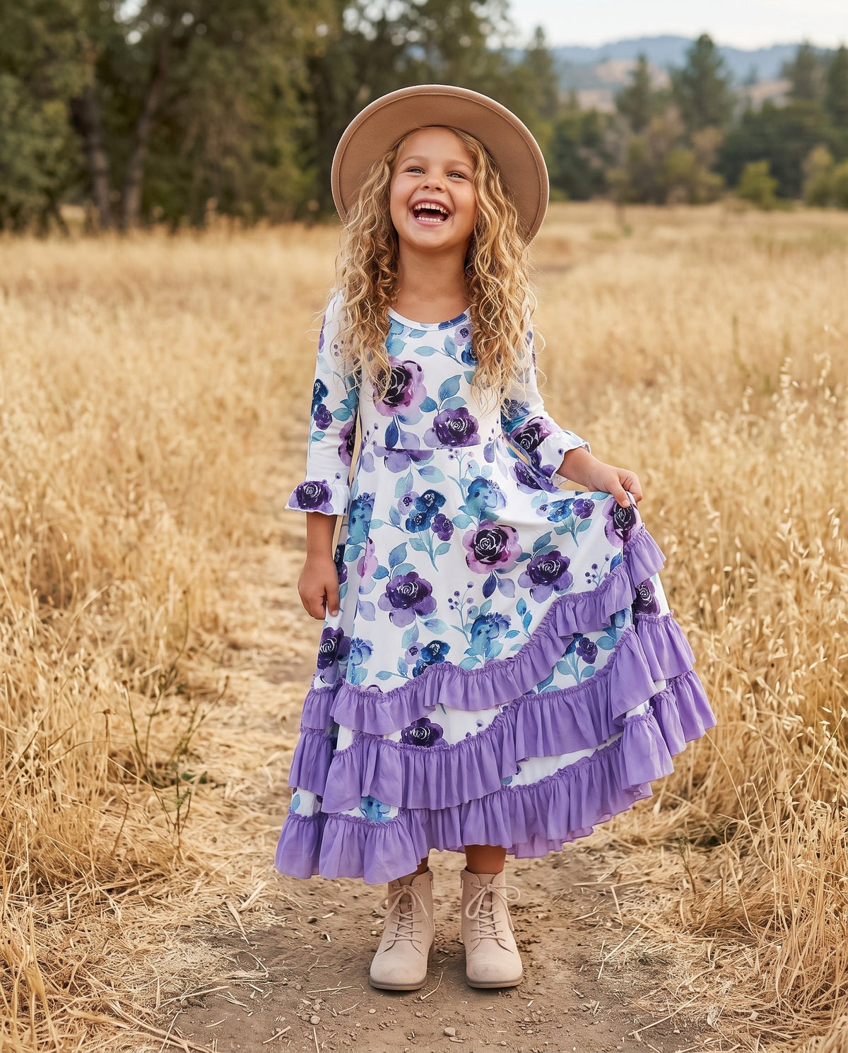 Young girl modeling a lavender floral long-sleeve dress outdoors.