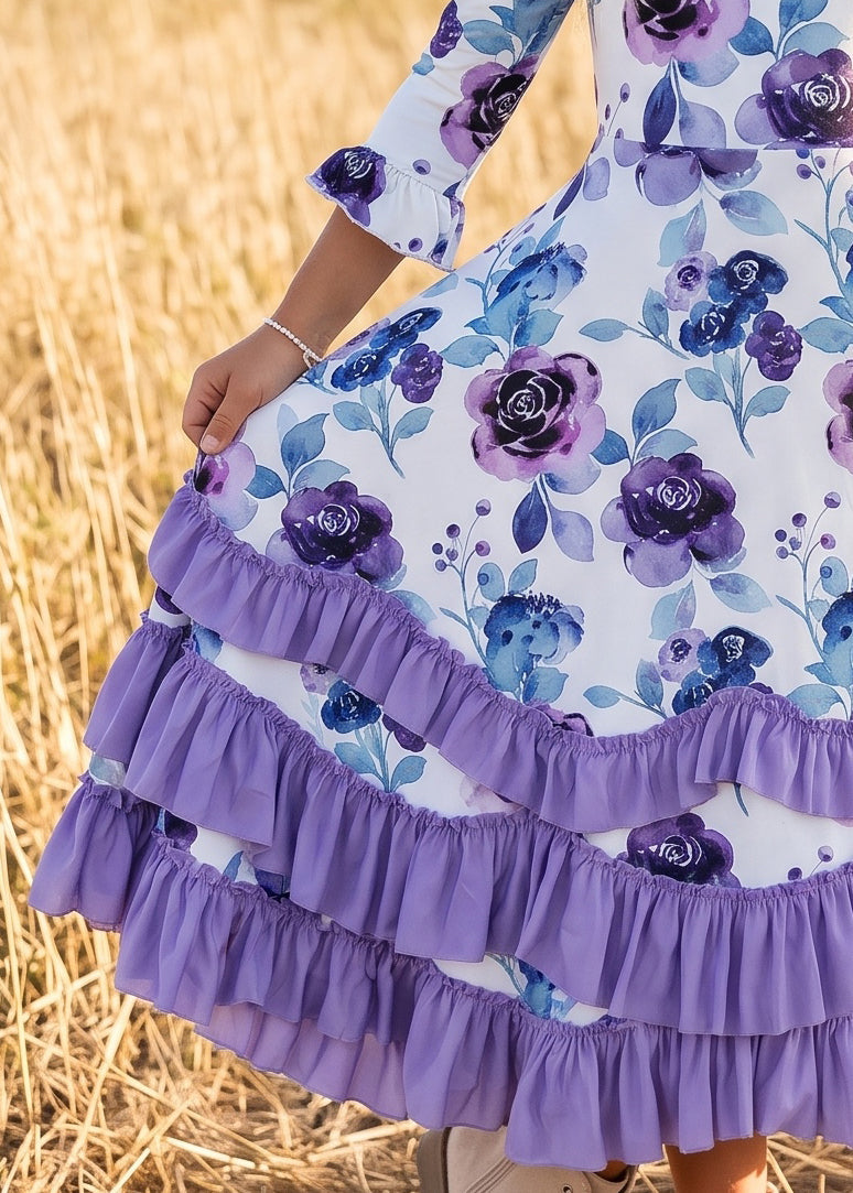 Close-up of purple layered ruffles on a girls' lavender floral dress.