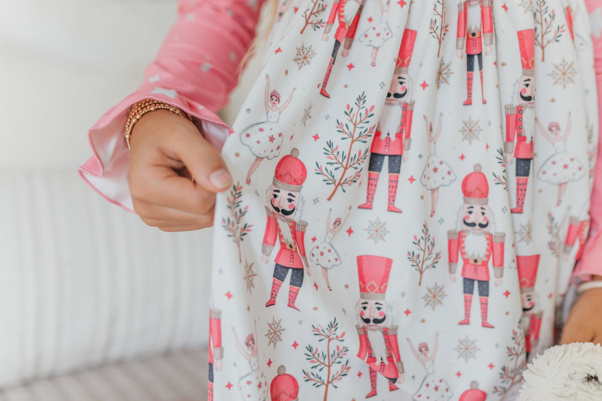 Girls' pink Nutcracker Christmas nightgown featuring festive star print, long sleeves, and pretty ruffle details.
