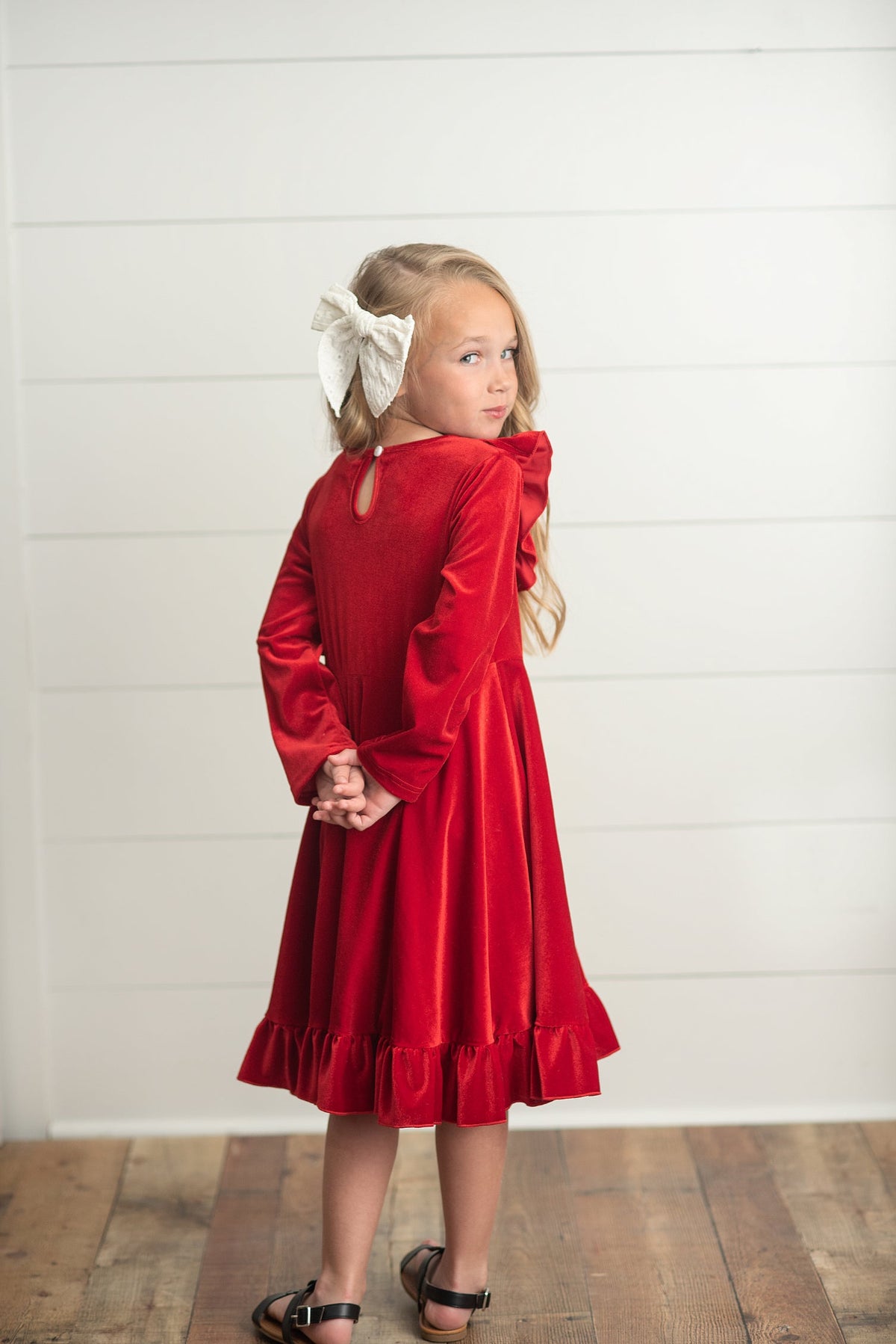 Back view of girls' red holiday dress showing skirt and silhouette.